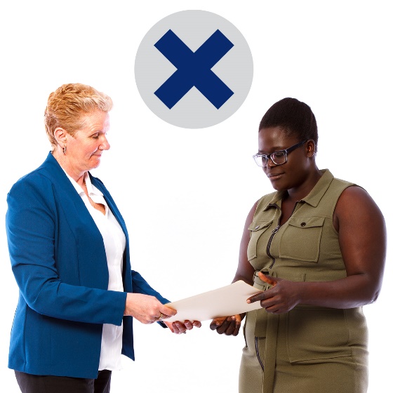 A woman handing a document to another woman, with a cross