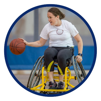 A woman in a wheelchair, playing basketball