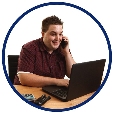 A man talking on the phone while using a laptop