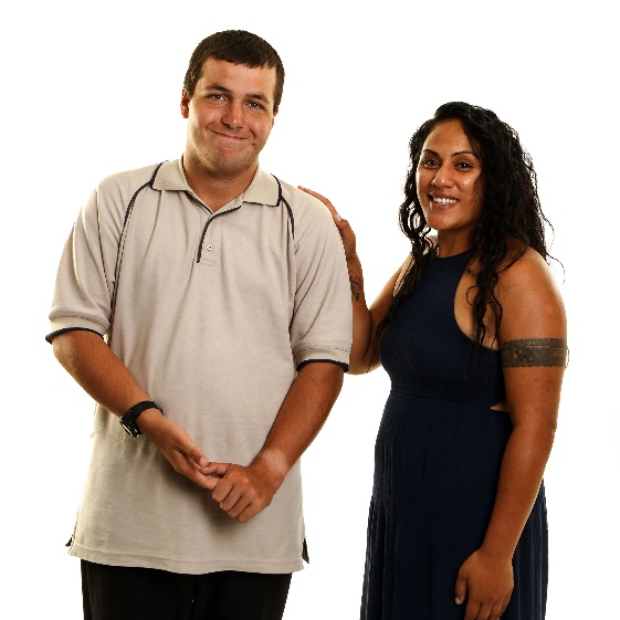 A woman standing next to a man with her hand on his shoulder.
