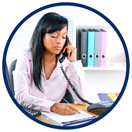 A woman talking on the phone while writing something down