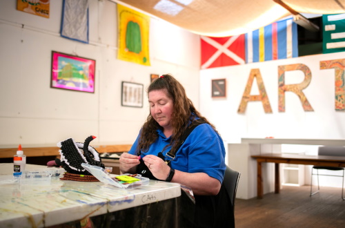An image of Ellie making origami