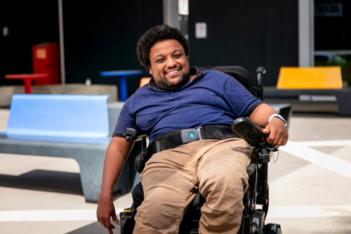 An image of Samson sitting outside in his motorised wheelchair.