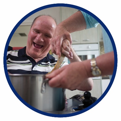 A man and a support worker cooking