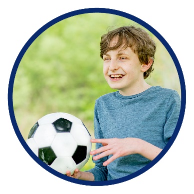 A boy holding a soccer ball