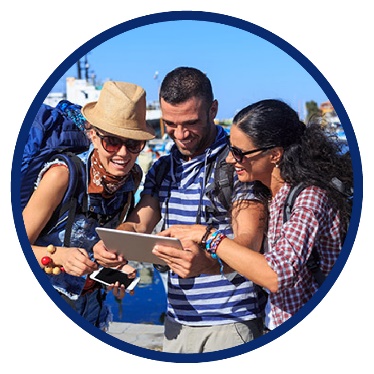 3 people using a tablet while on a holiday