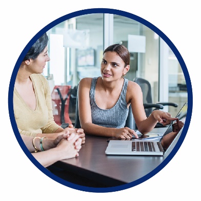 2 women using a laptop together