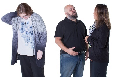 A man and a woman talking about another woman, who is looking down