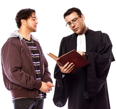 A man talking to a lawyer, who is reading something in a book