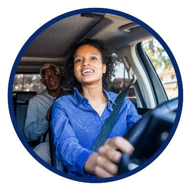 A woman driving with a passenger in the back