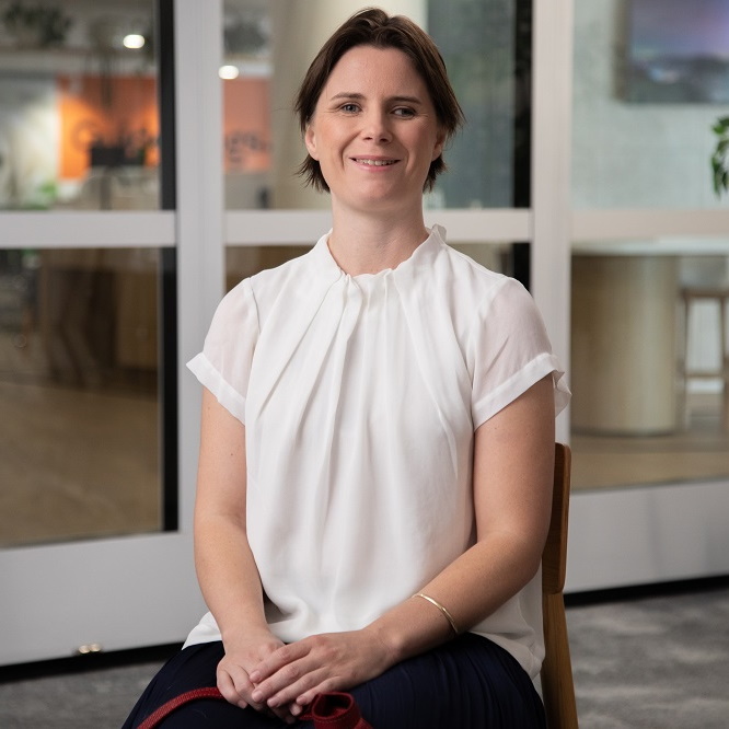 An image of Sarah smiling at work