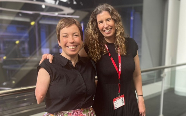 Two women smiling at the photographer