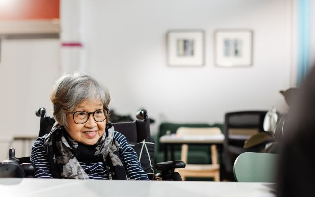 Asian lady sitting in a wheelchair